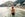 Rear view of a young beautiful woman admiring Positano town in Italy. She's bathing in the sea. Italy vacation concept like Dolce Vita.
